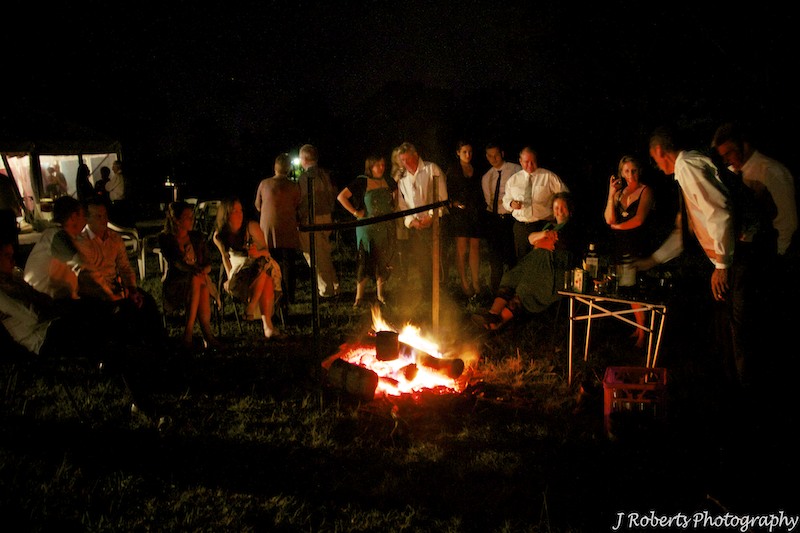 Guests around the fire - wedding photography sydney